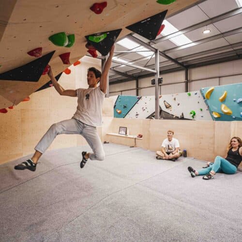 Man is bouldering on an indoor wall in Cardiff