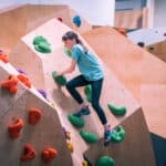 A young girl climbing at Flaspoint's bouldering centre in Cardiff